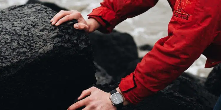 person in red jacket wearing silver and black watch